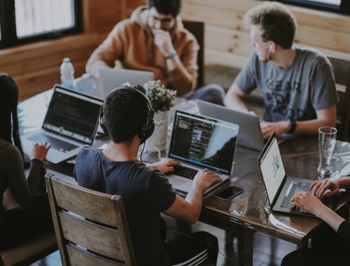 group of people using laptop computer